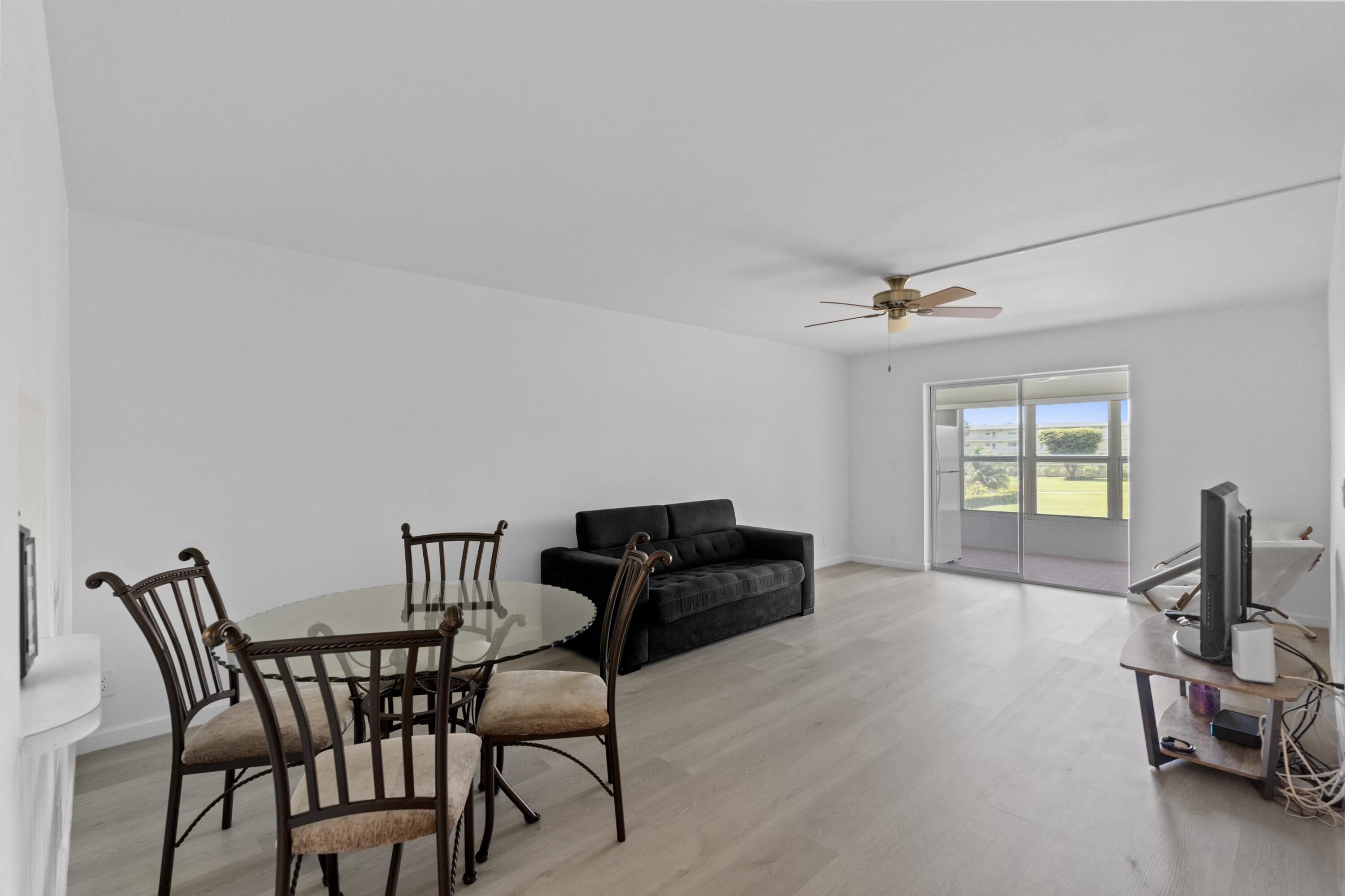 a view of a livingroom with furniture and a window