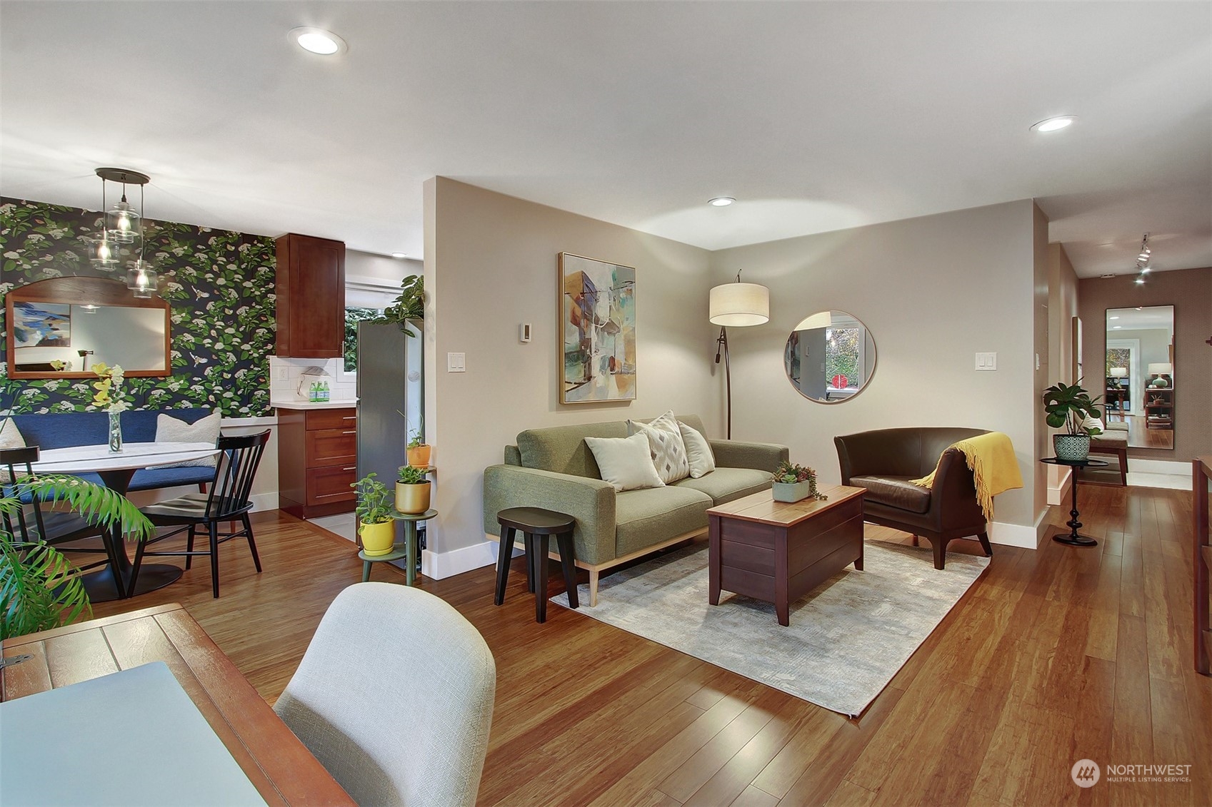 a living room with furniture and wooden floor