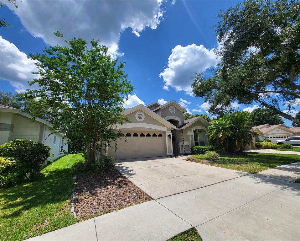 a front view of a house with a yard and a garage