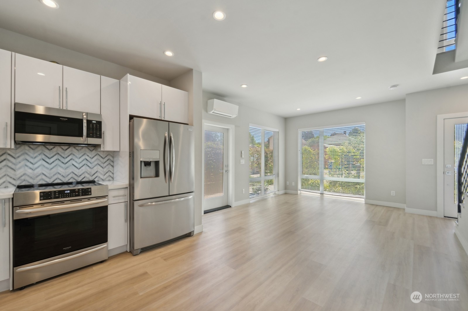 a kitchen with granite countertop a refrigerator stove and wooden floor