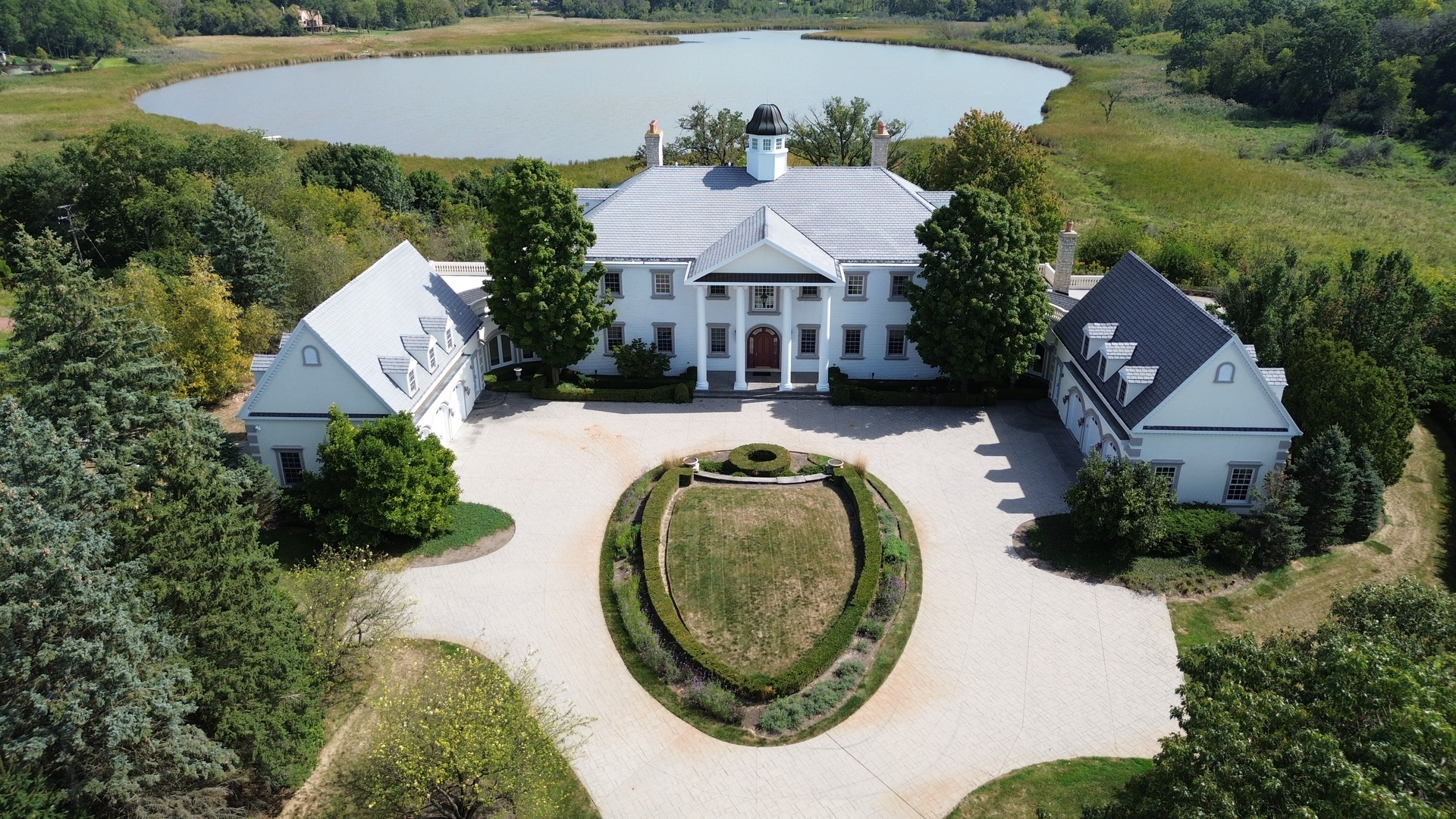 an aerial view of a house with swimming pool and outdoor space