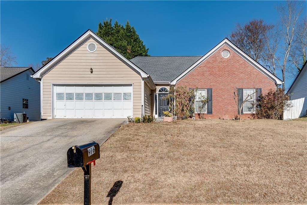 a view of a house with a yard and garage