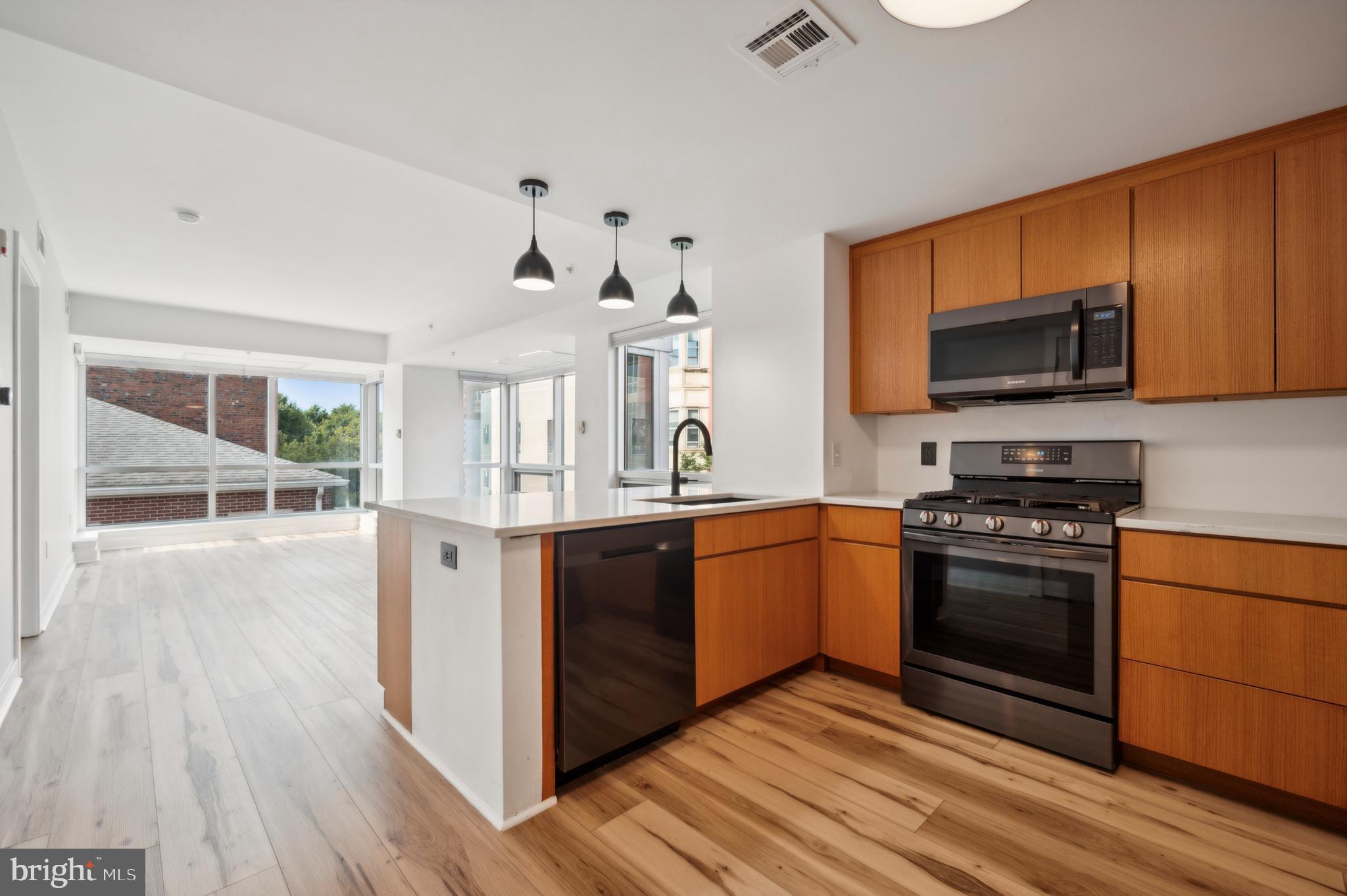 a kitchen with stainless steel appliances granite countertop a stove and a sink