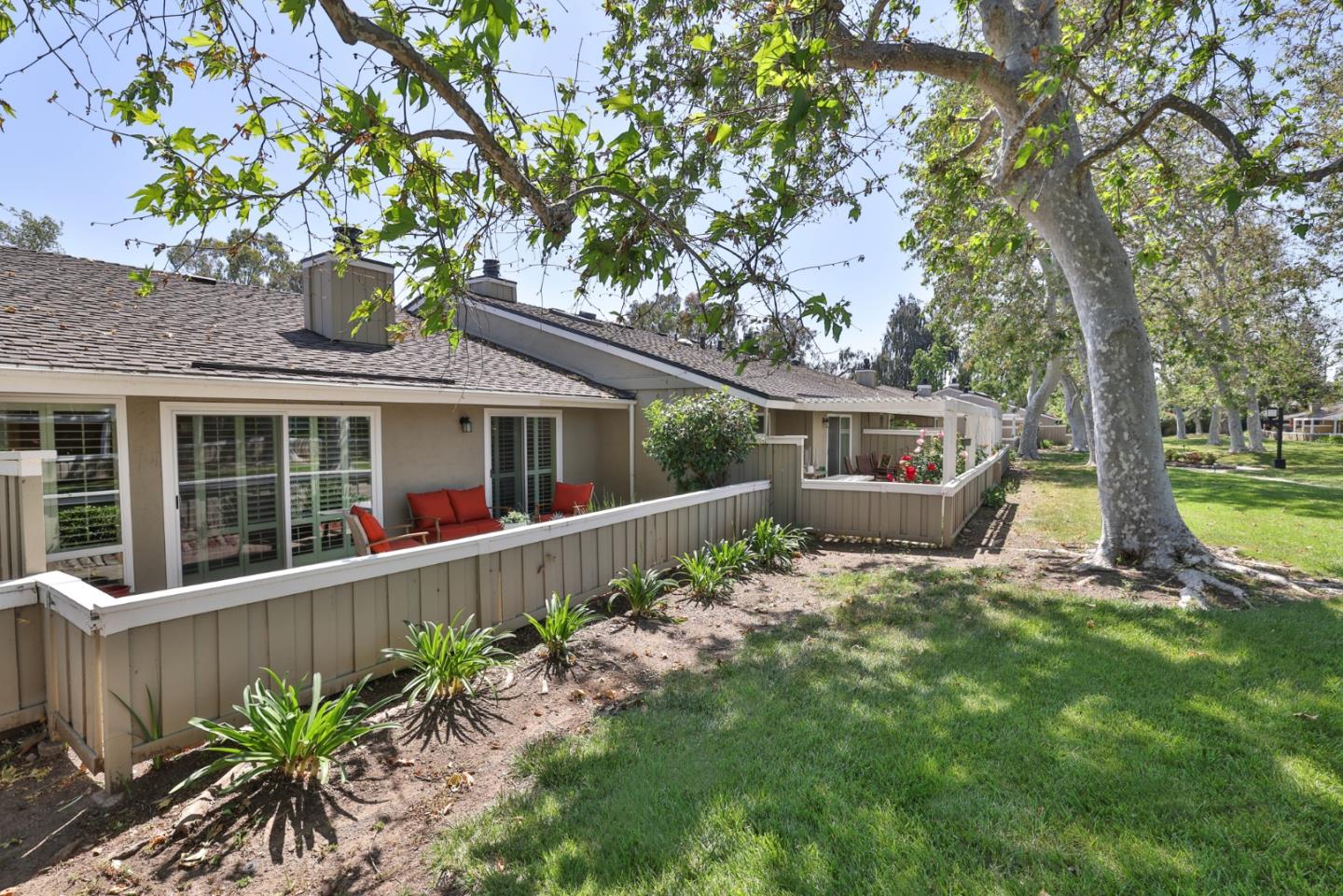 a front view of house with a garden