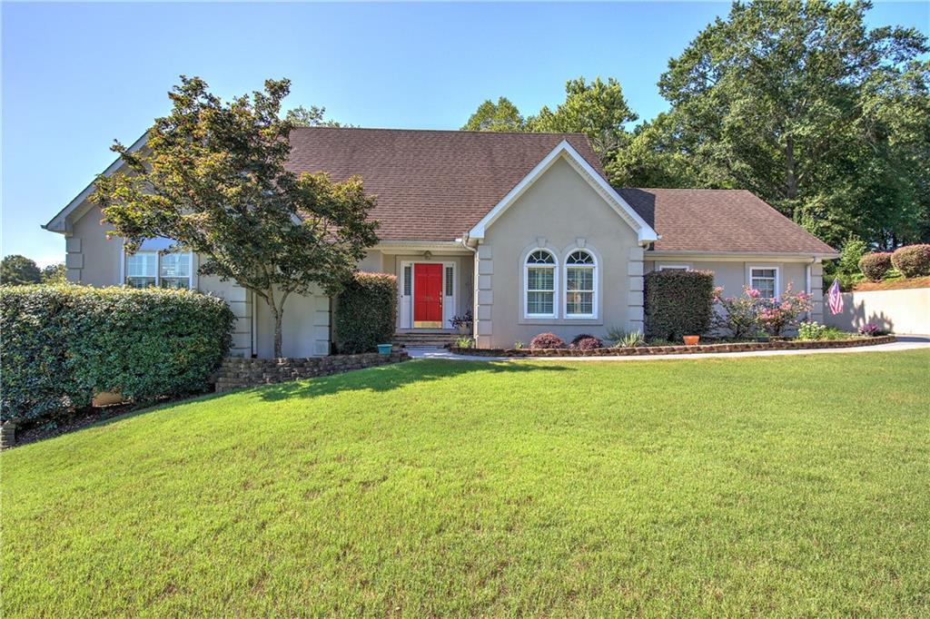 a front view of house with yard and green space