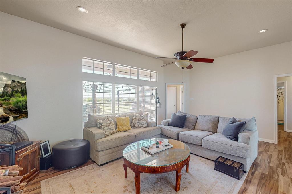 a living room with furniture a flat screen tv and a window