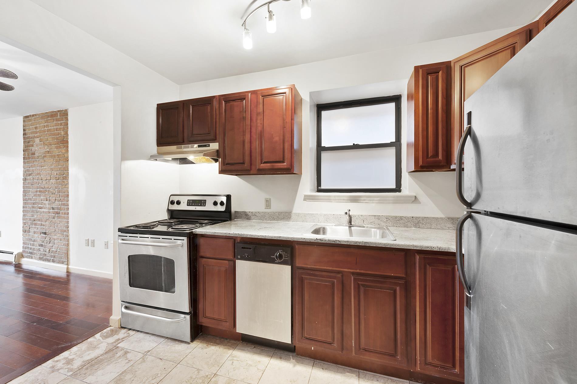 a kitchen with stainless steel appliances granite countertop a stove a sink dishwasher and a refrigerator