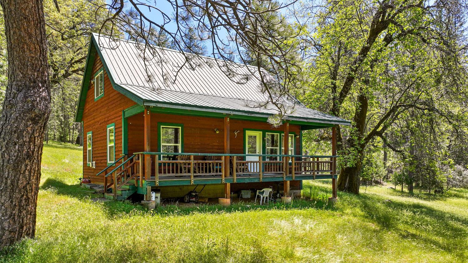 a view of a house with a yard patio and fire pit