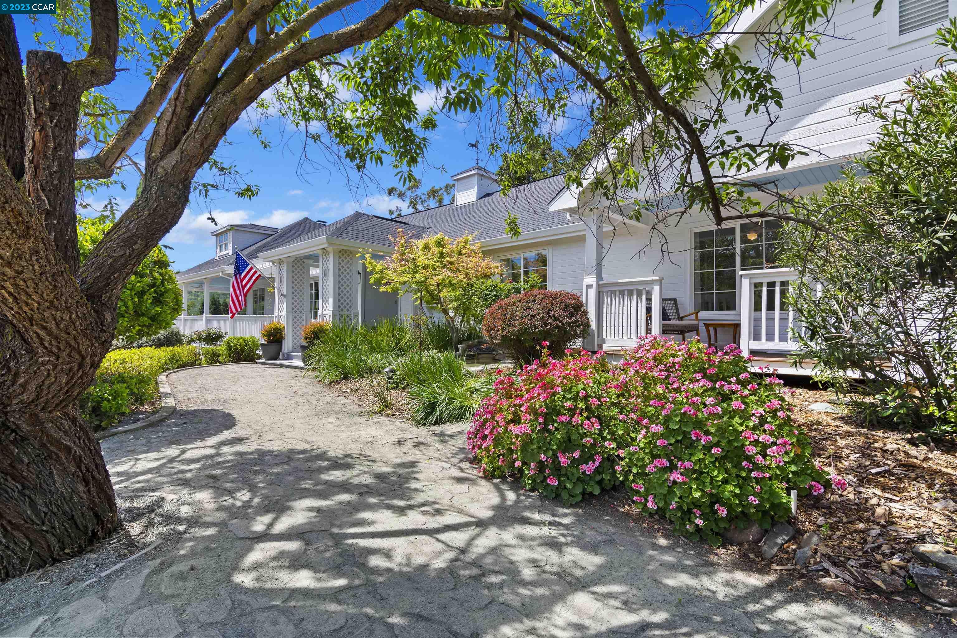 a front view of a house with a yard and fountain