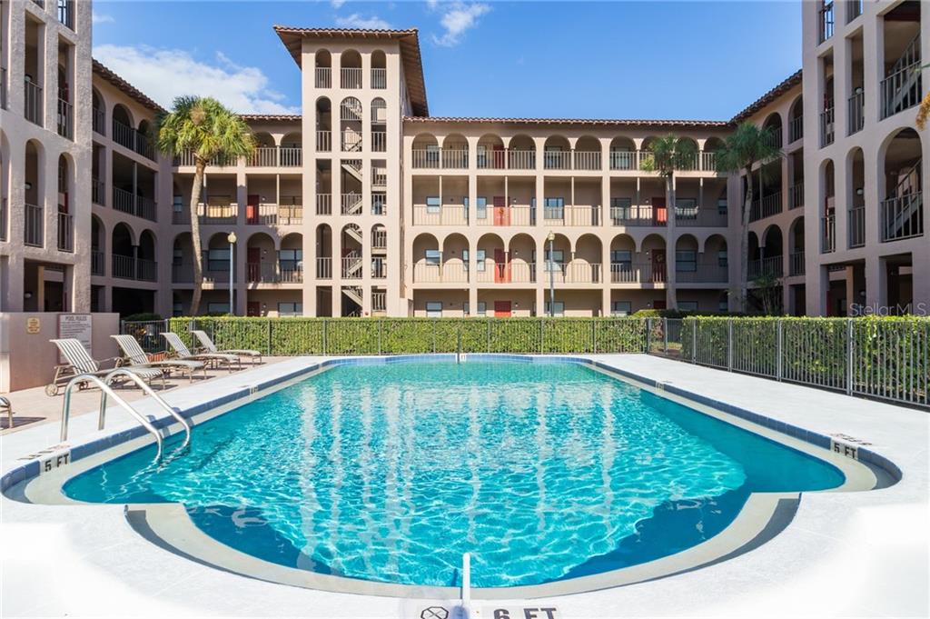 a view of swimming pool with outdoor seating