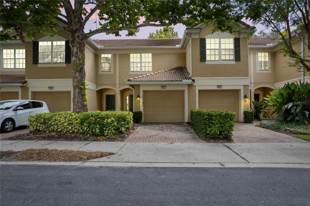 a front view of a house with a yard and a garage