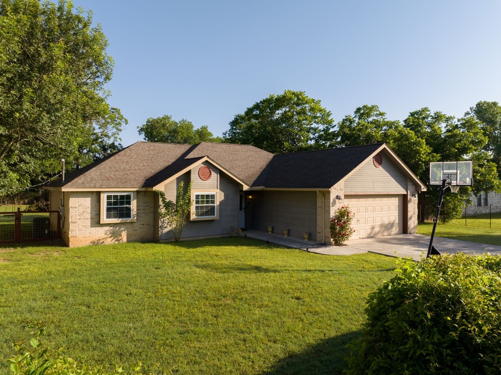 a front view of house with yard and green space