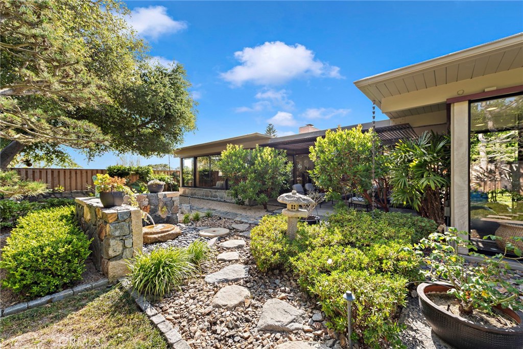 a view of a patio with table and chairs potted plants