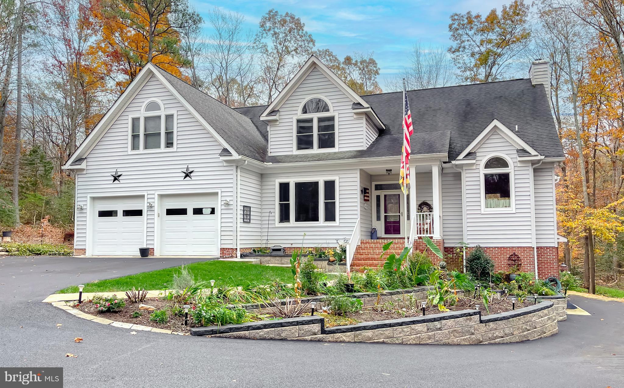 a front view of a house with a garden and plants