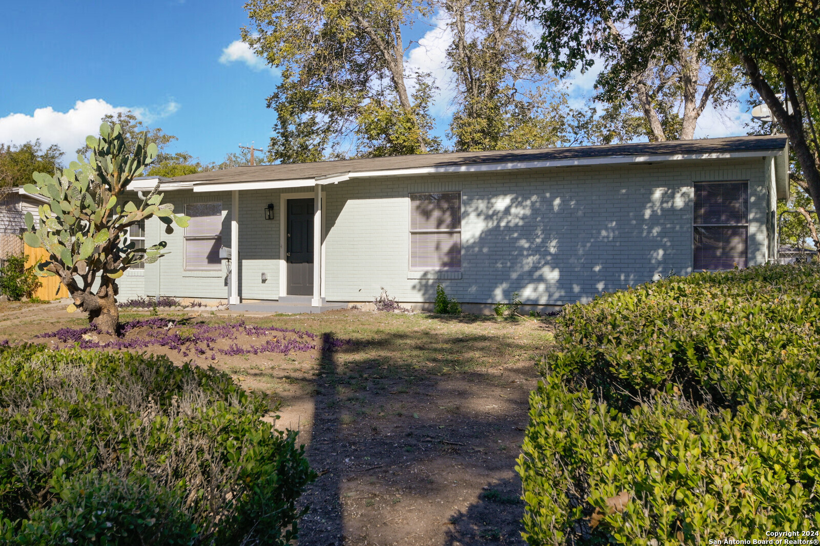 a view of a house with a tree