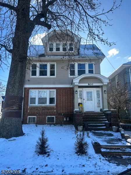 a front view of a house with a yard balcony