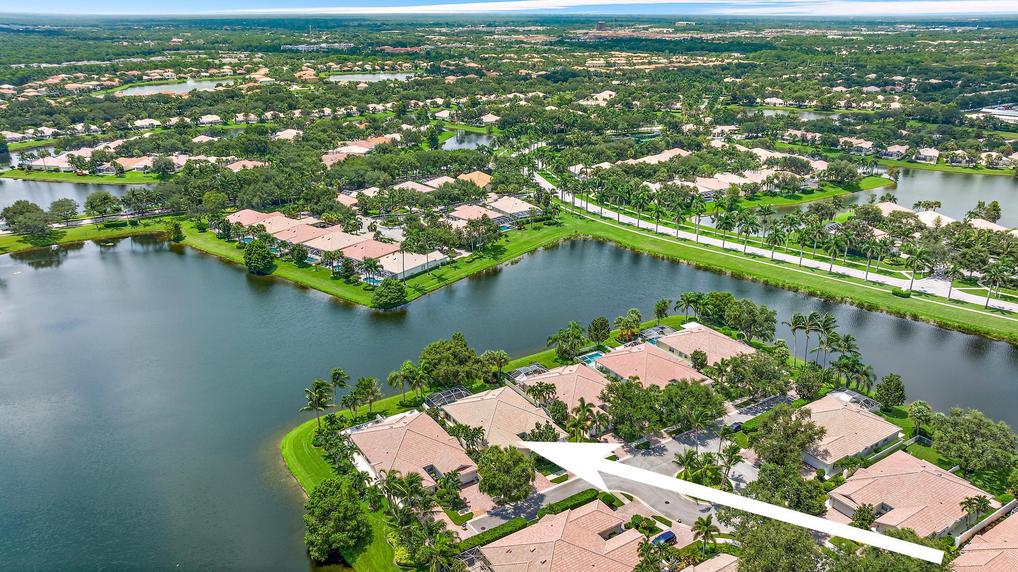 an aerial view of residential houses with outdoor space and lake view