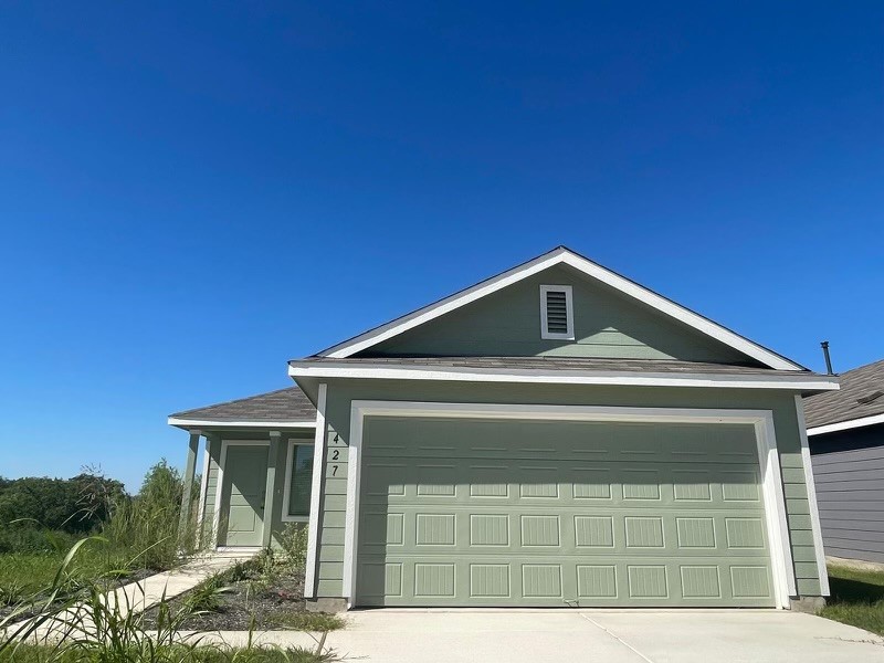 a front view of a house with garage