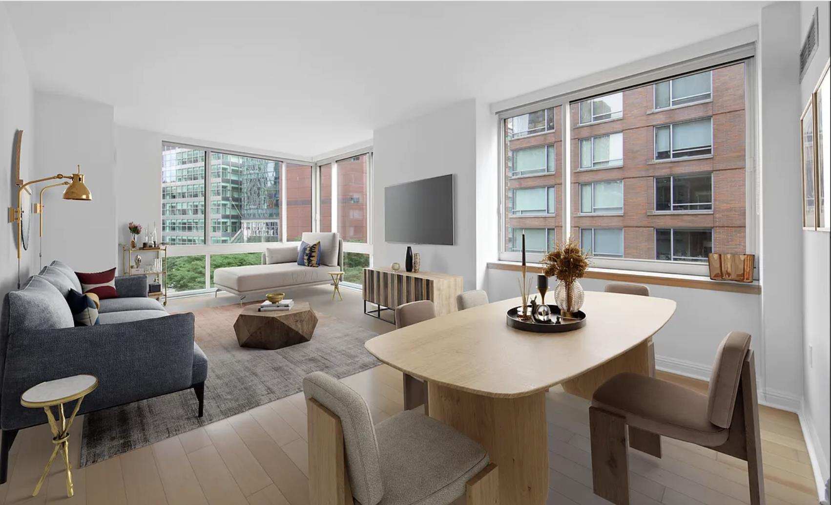 a dining room with furniture a large window and a table