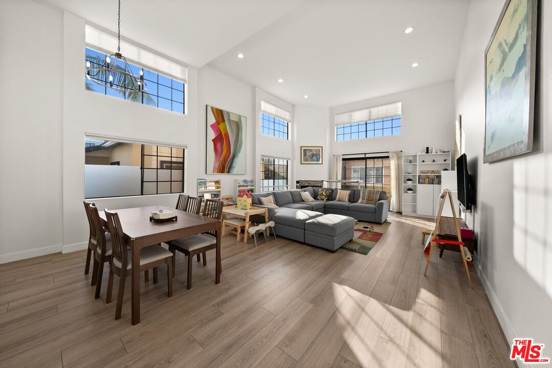 a living room with furniture wooden floor and a flat screen tv