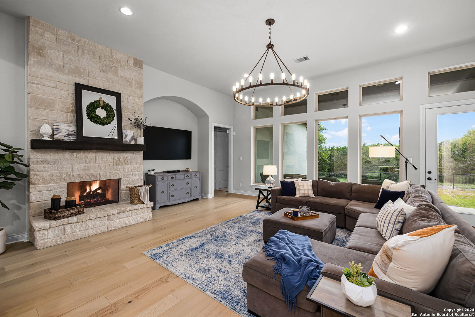 a living room with furniture a fireplace and a flat screen tv