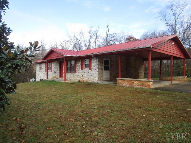 a view of a house with a yard and tree