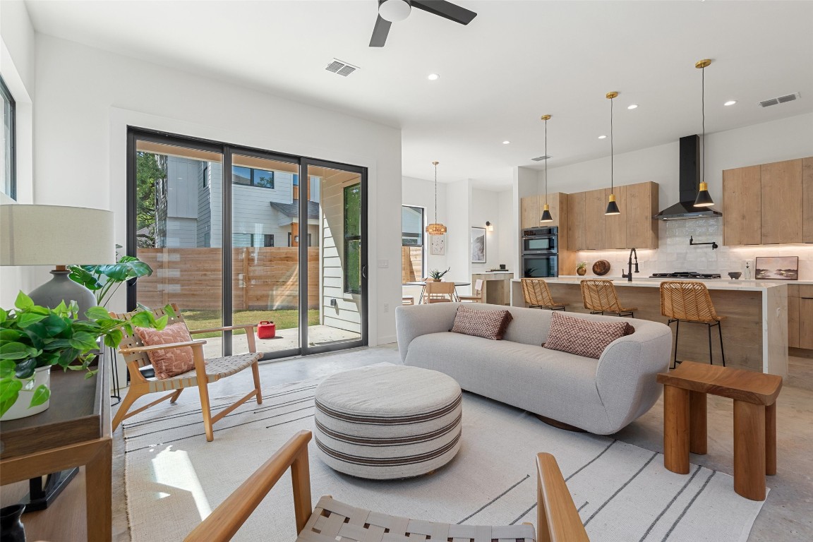 a living room with furniture and a large window