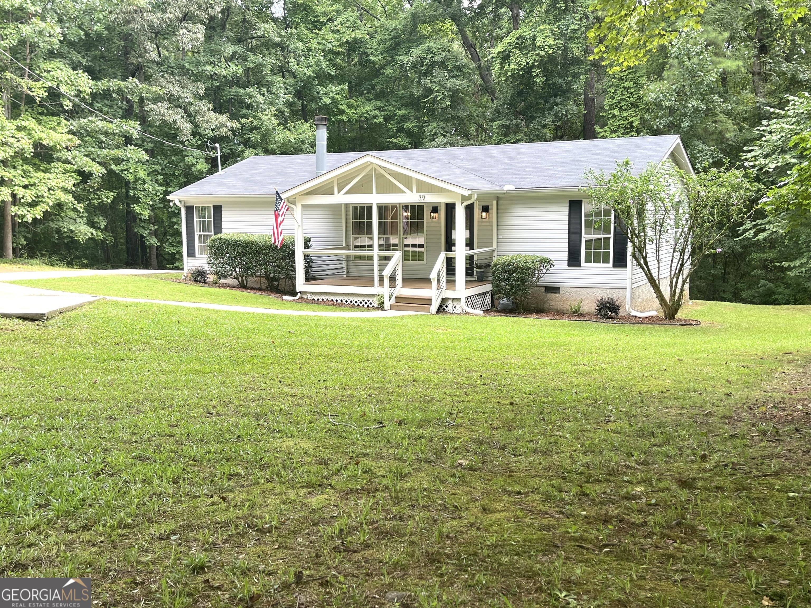 a view of a house with a yard and sitting area