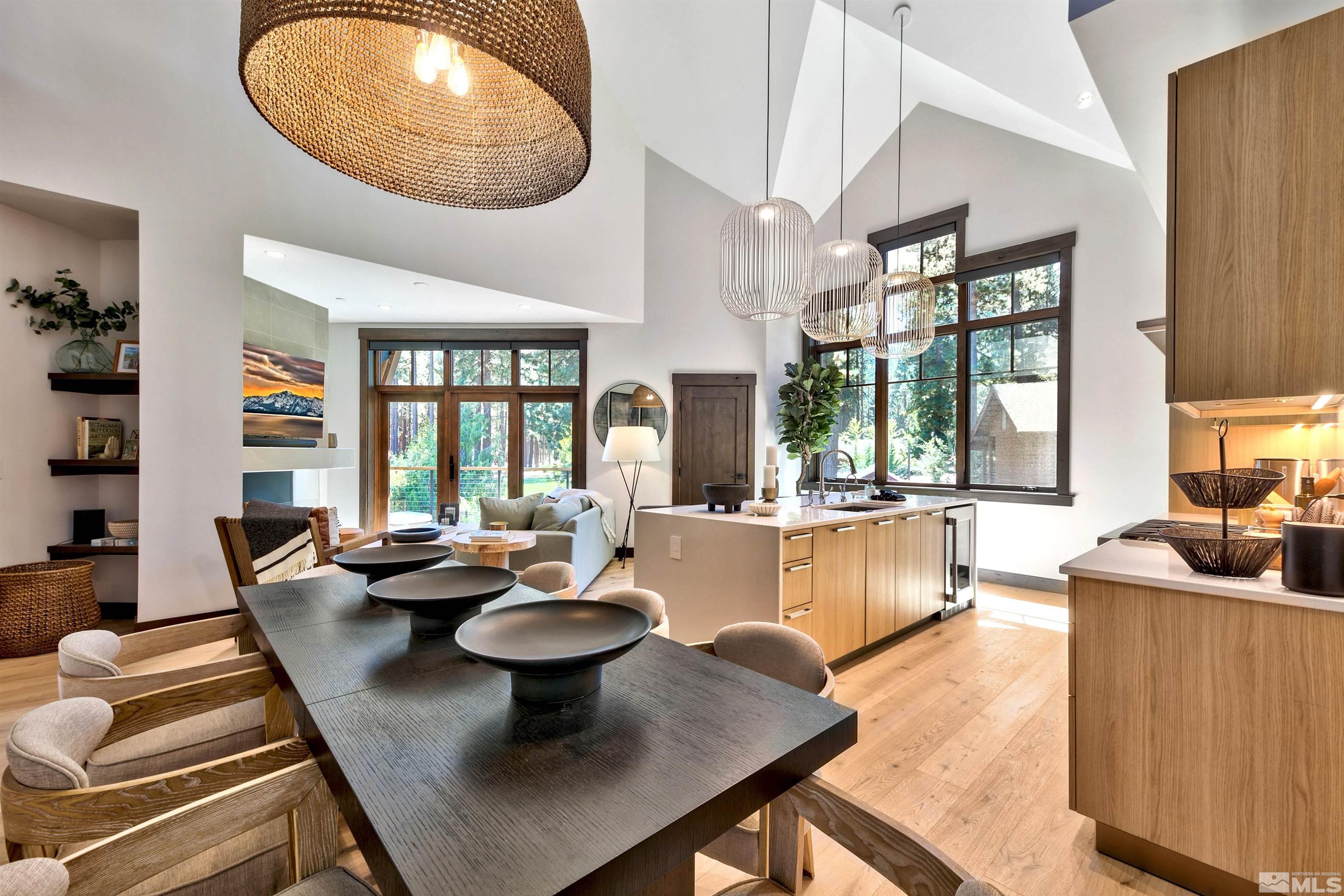 a dining room with furniture a large window and a table