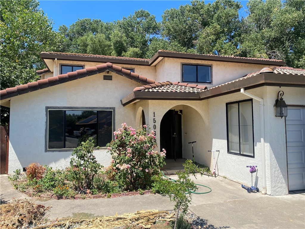 a front view of a house with garden