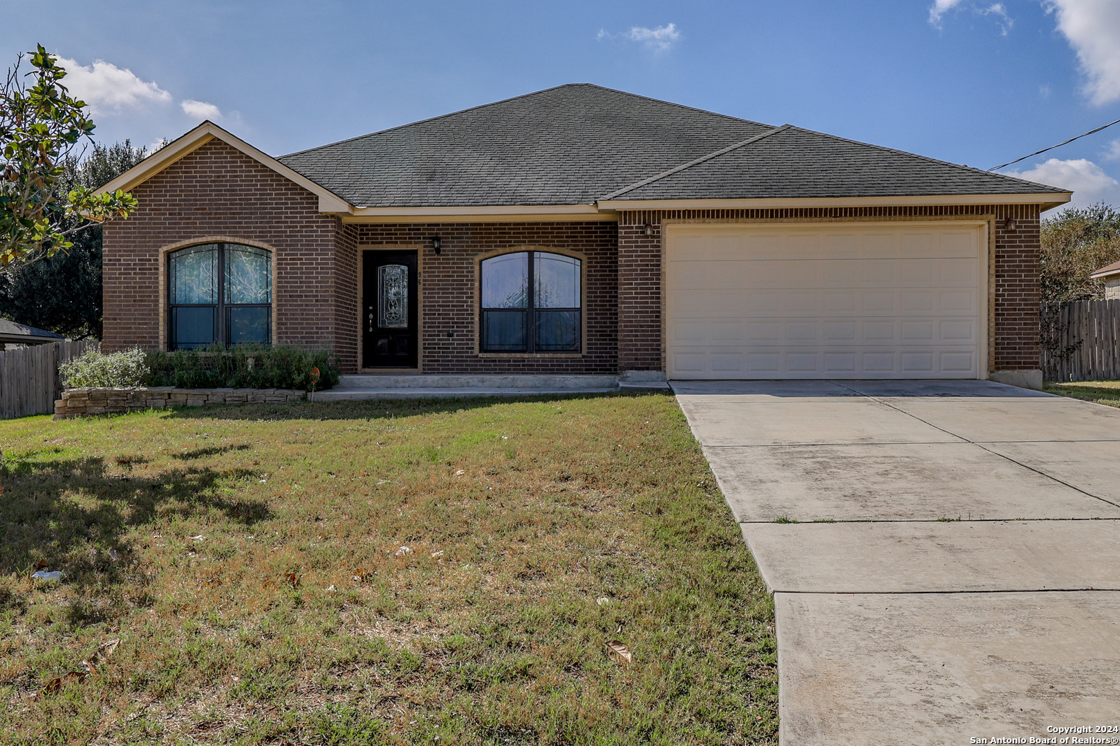 a front view of a house with a yard