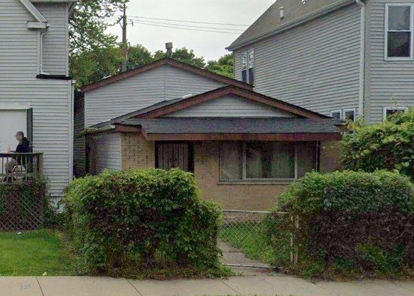 a front view of a house with plants