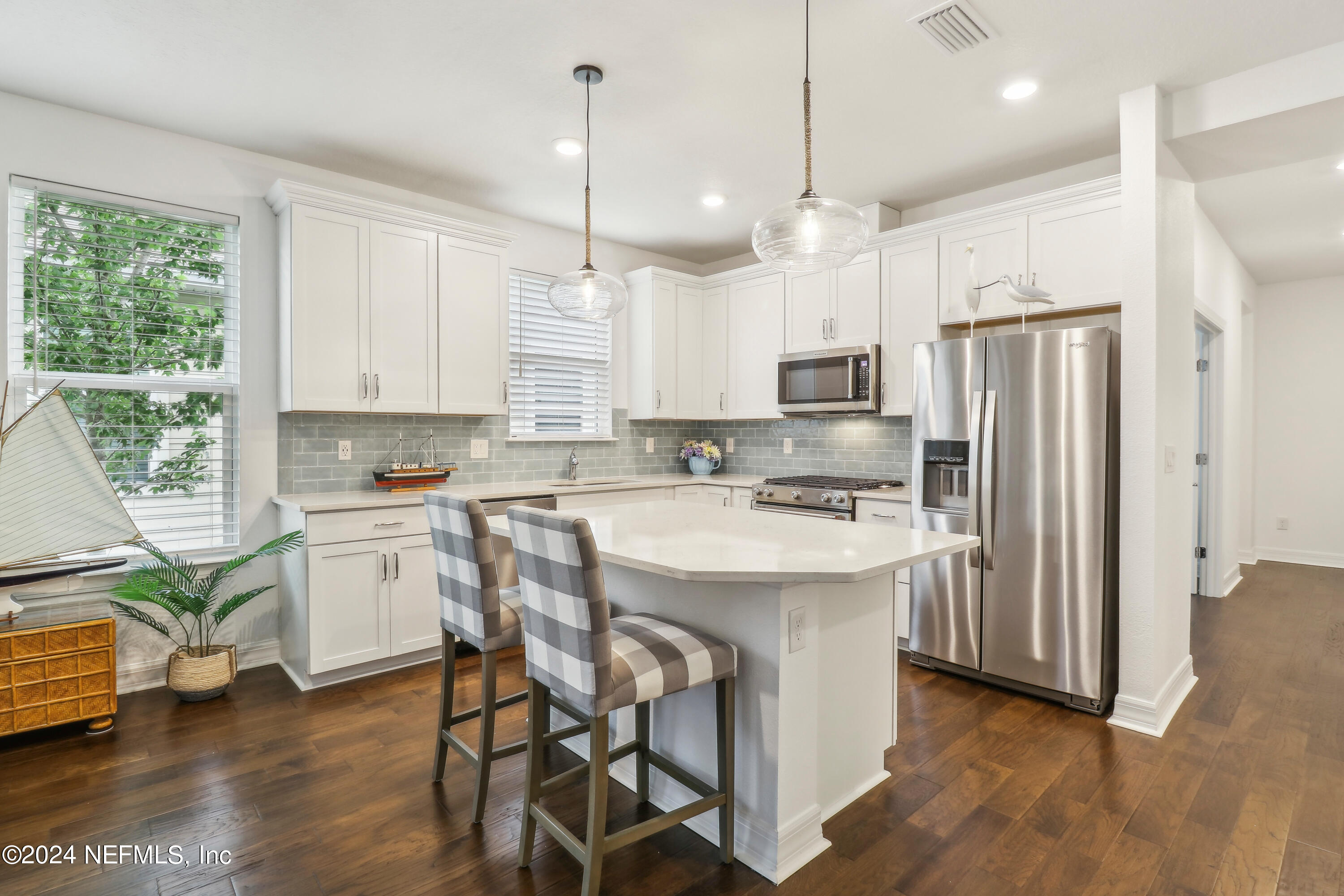 a kitchen with a refrigerator a sink and cabinets