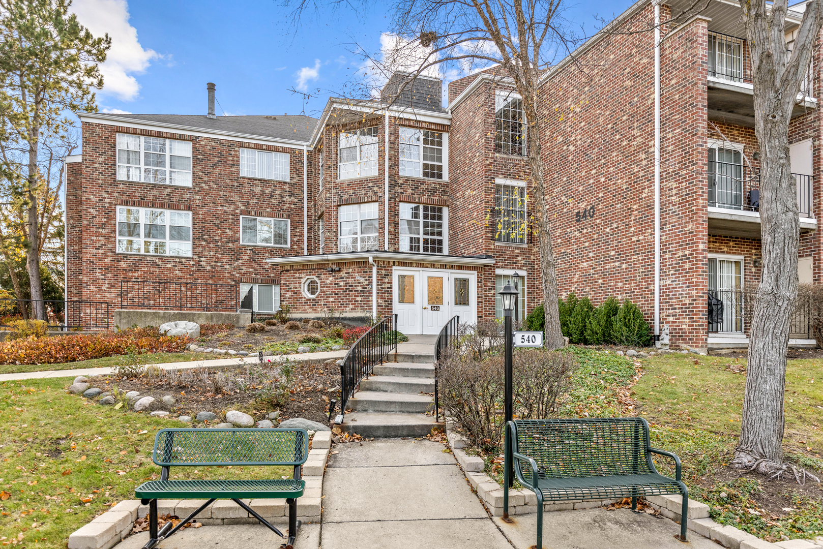 a front view of a brick house with a yard