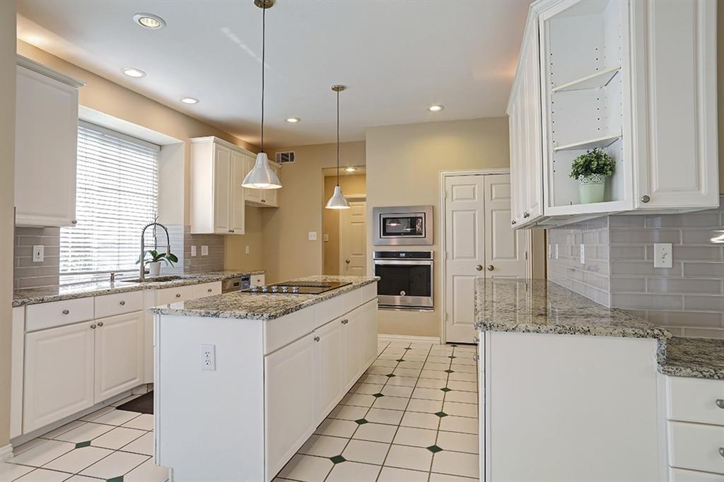 a kitchen with a sink stove and cabinets