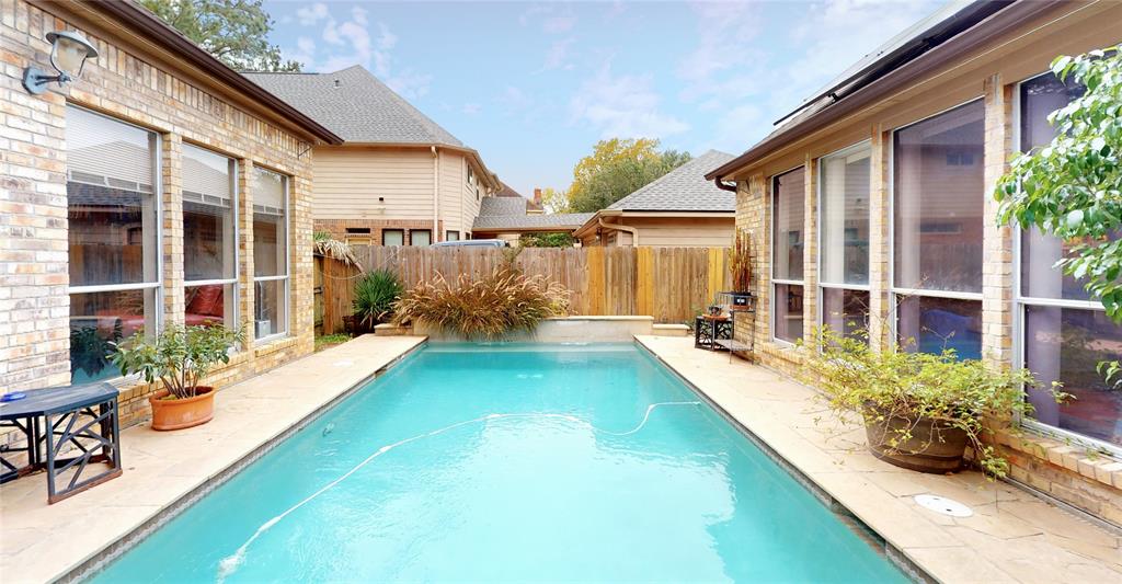 a view of a house with swimming pool in front of it