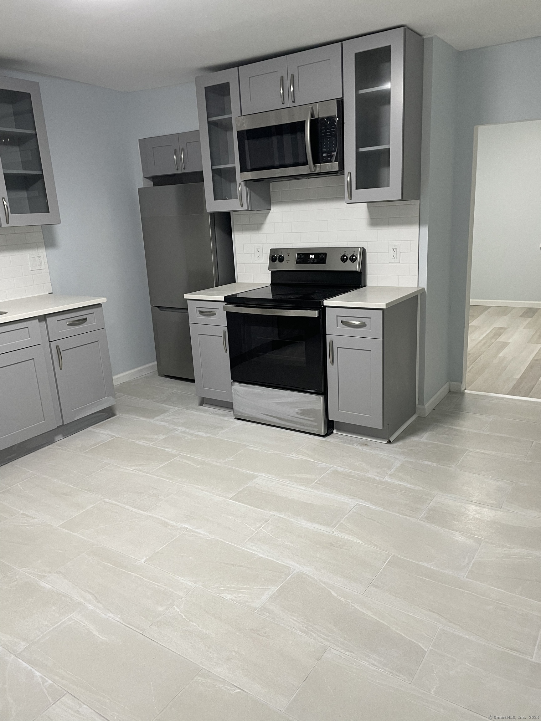 a kitchen with stainless steel appliances granite countertop a stove and a refrigerator