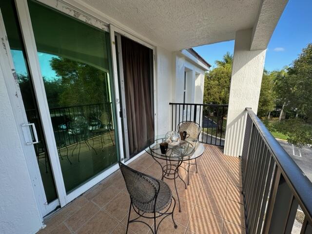 a balcony view with a seating space