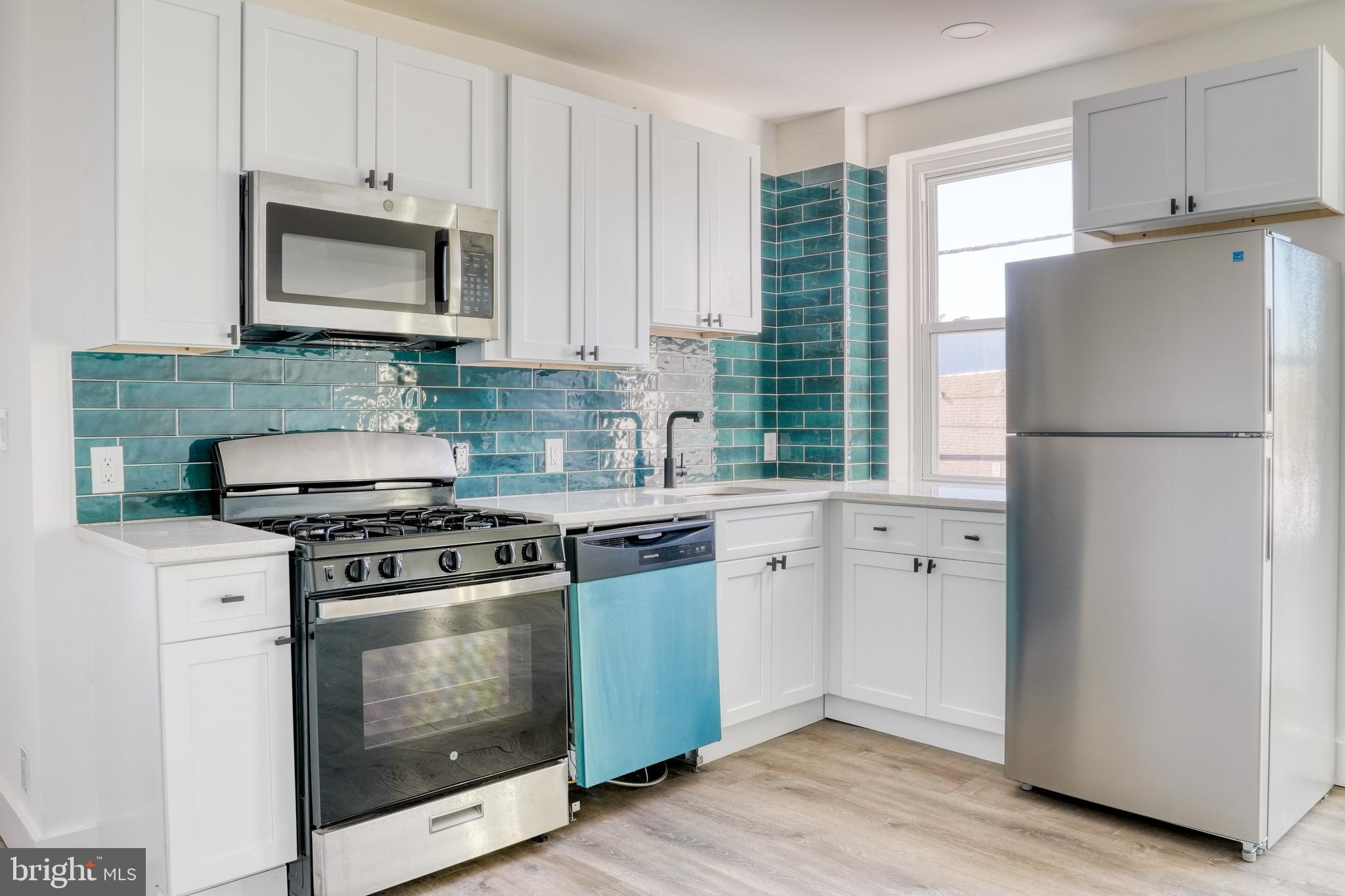 a kitchen with a stove microwave and refrigerator