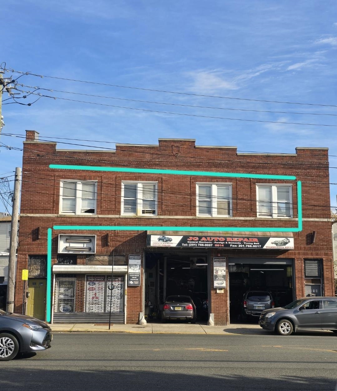 a view of a building and a car parked on the road