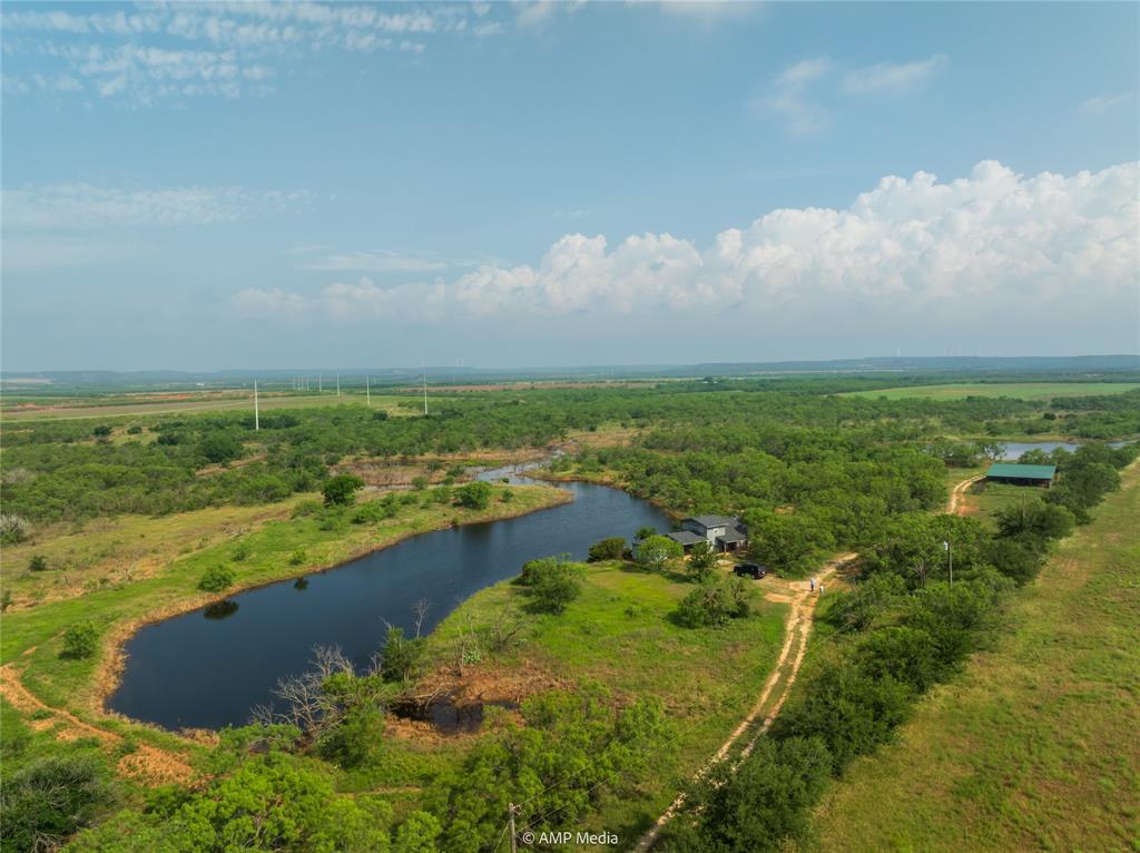 an aerial view of ocean with residential houses with outdoor space