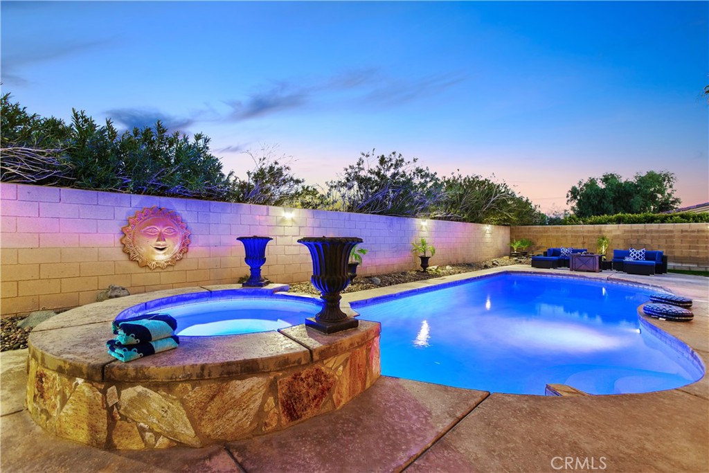 a view of swimming pool with outdoor seating and yard in back