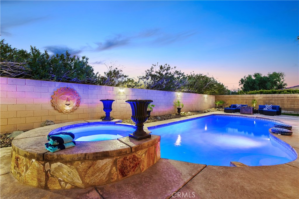 a view of swimming pool with outdoor seating and yard in the back