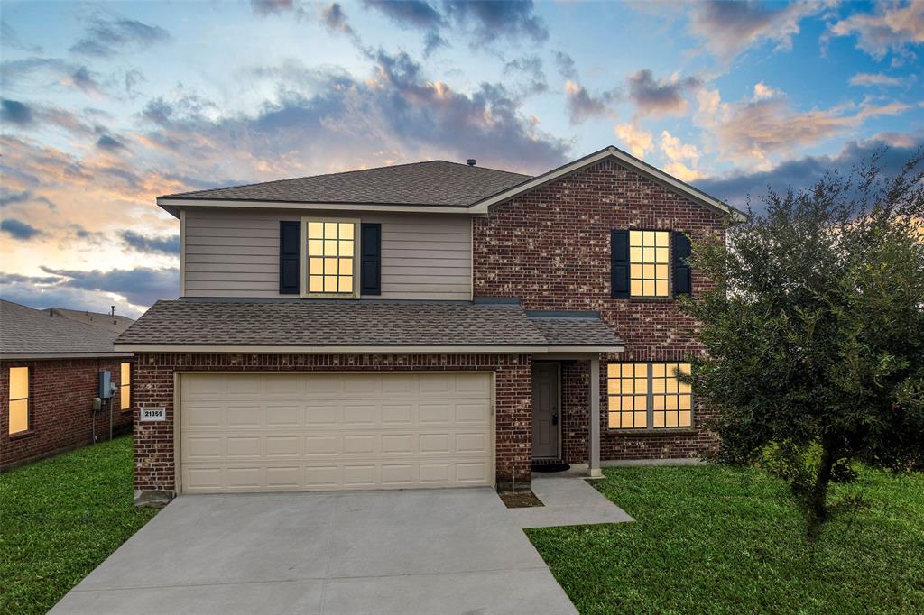 a front view of a house with a yard and garage