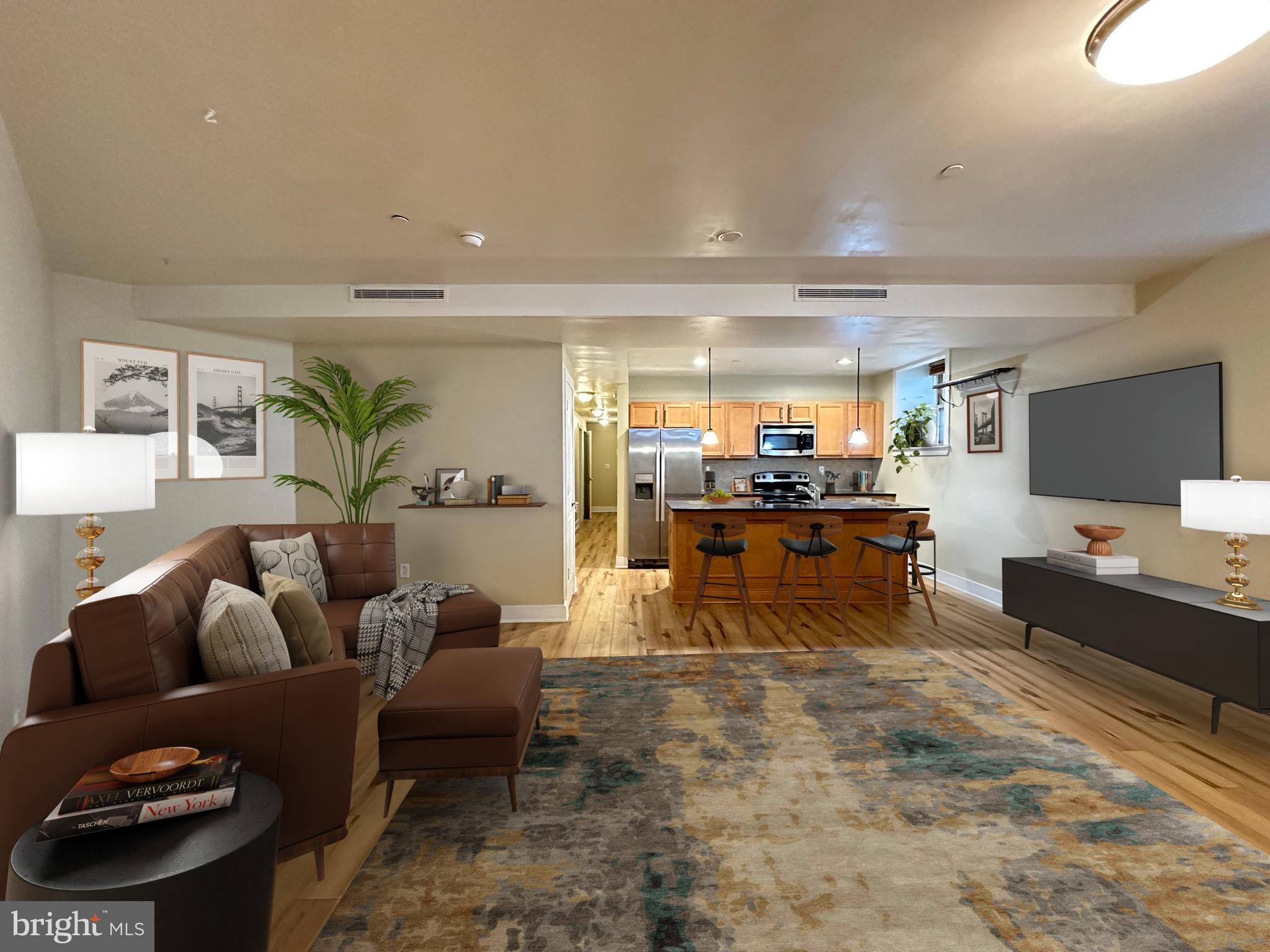 a living room with furniture and view of kitchen