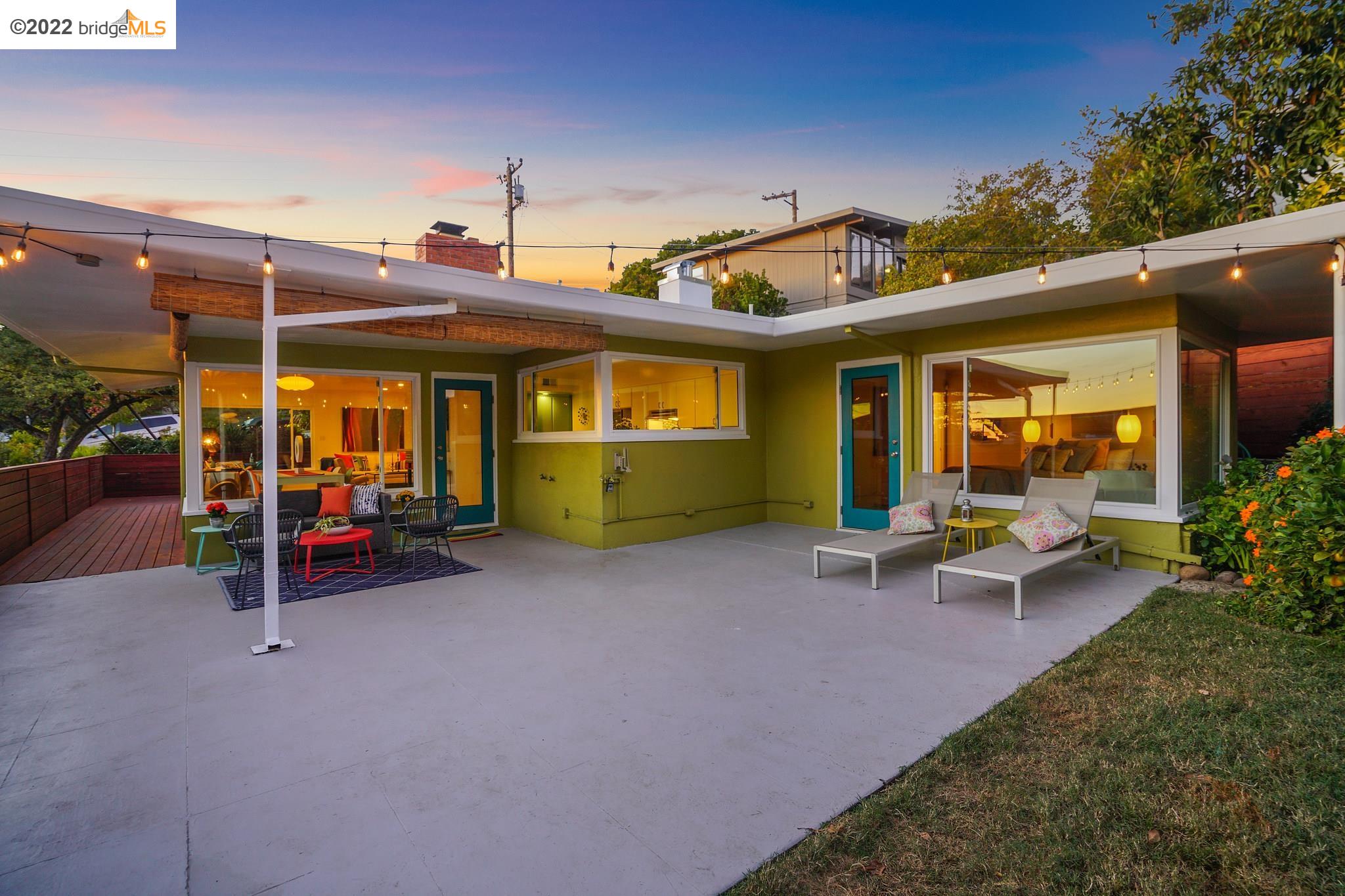 a view of a house with backyard sitting area and garden