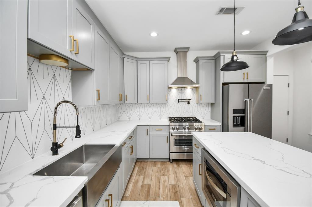 a kitchen with a sink a stove and refrigerator