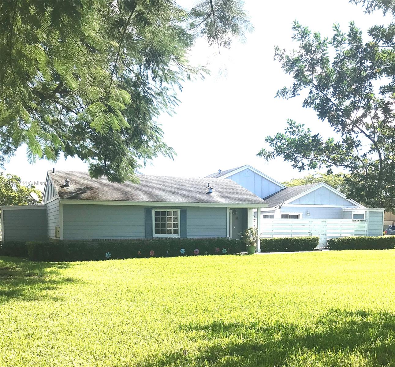 a front view of a house with a garden