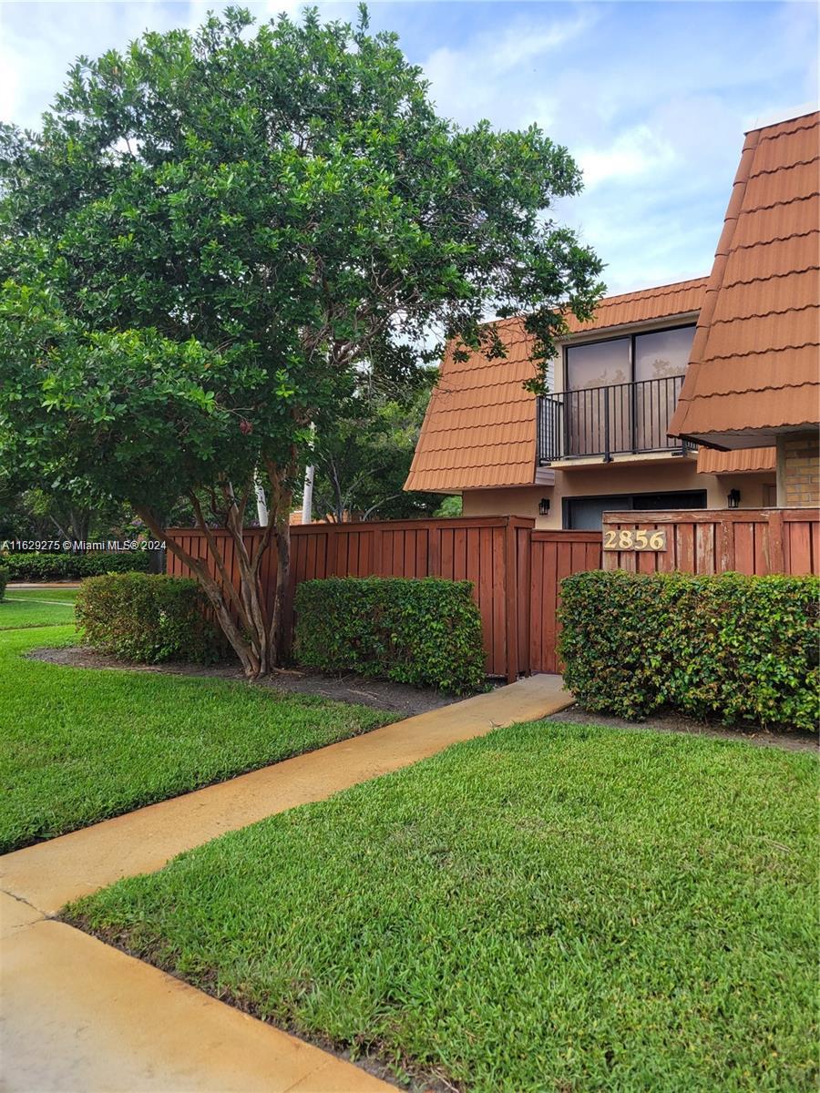 a view of an house with backyard space and garden