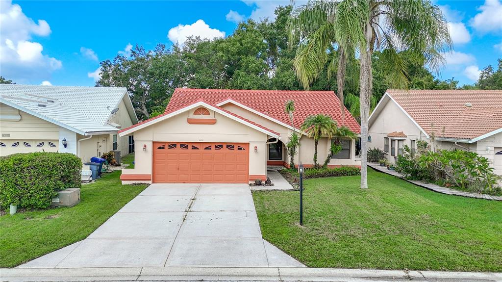 a front view of a house with a yard and garage